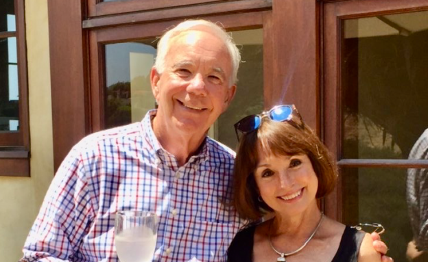 Man and woman posing together and smiling.