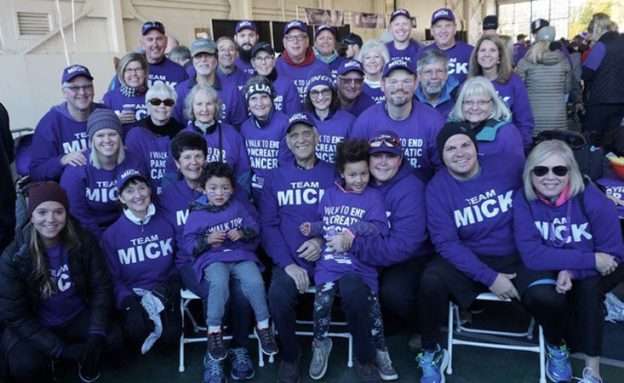 Group wearing purple sweatshirts saying Team Mick on them at PanCAN PurpleStride.